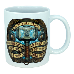 The Mug: Viking Energy of Thor Ceramic Mug (11 oz) by Nordic Wholesale is a white mug showcasing Thor’s hammer with intricate Norse designs and the inscription: “Whosoever holds this mug and drinks from it, if they be worthy, shall possess the energy of Thor.”.