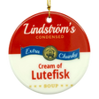Round ornament styled like a soup can label, text reads Lindströms Condensed Extra Chunky Cream of Lutefisk Soup, gold hanging string attached.