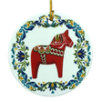 Round ceramic ornament featuring a red Swedish Dala horse with a blue and green floral rosemaling border.