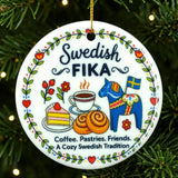 Round ornament with Swedish Fika designs, including coffee, pastries, cake, blue horse, Swedish flag, and flowers, hanging on a Christmas tree.