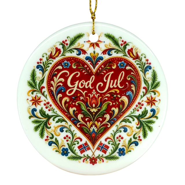 Ceramic Nordic ornament with a red heart, floral accents, “God Jul” at the center, and two small Norwegian flags below in traditional folk art style.