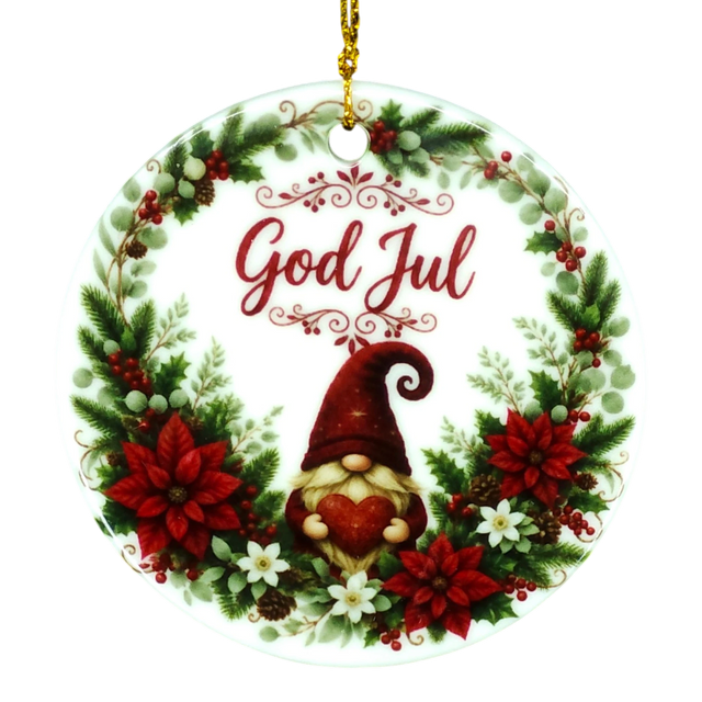 Round ornament with “God Jul,” showing a gnome holding a heart inside a wreath of poinsettias, pine, berries, and white flowers in a Nordic holiday style.