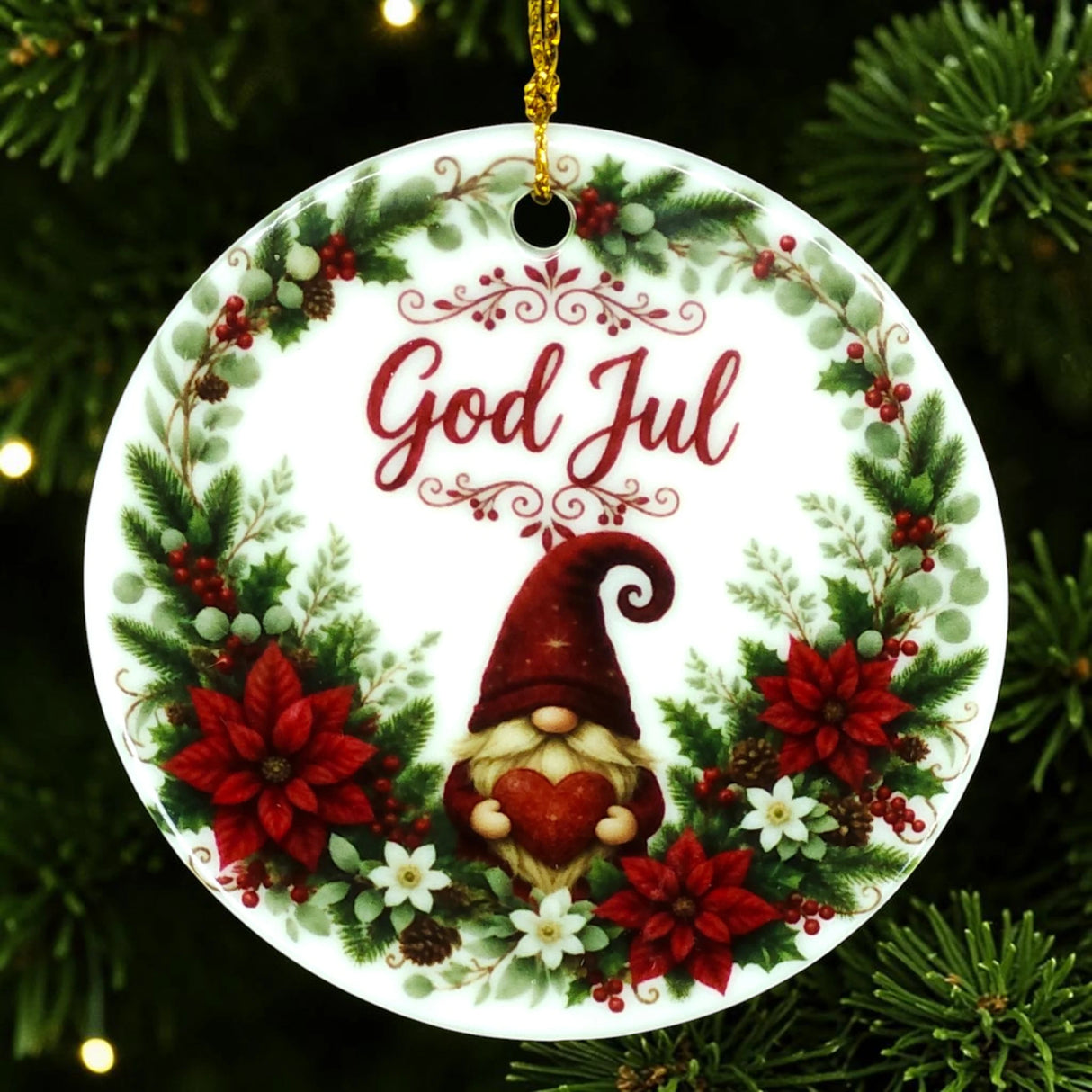 Round Scandinavian ornament featuring “God Jul,” a gnome holding a heart, and a border of red flowers with greenery, shown hanging on a Christmas tree.