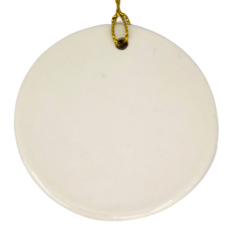 A round white ceramic ornament by Nordic Wholesale, the "Lindstrom Water Tower Floral Ceramic Ornament" (2.875" diameter), hangs against a white background with a gold string looped through a small hole at the top. Its simple elegance offers a subtle nod to kurbits folk art traditions.