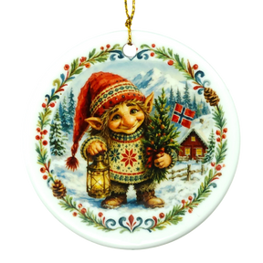 Round ornament with a gnome in a red hat holding a lantern next to a tree, snowy cabin, Norwegian flag, and pinecones. Scandinavian holiday design.
