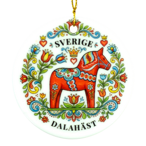 Round ornament showing a red Dala horse with colorful floral designs, the word SVERIGE above and DALAHÄST below.