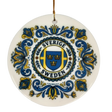 The Ornament: Sverige Sweden Triple Crown Ceramic Ornament (2.875" Diameter) by Nordic Wholesale showcases blue and yellow floral patterns surrounding a central shield with three crowns and the words "Sverige Sweden." A gold string is attached at the top, making this Swedish ceramic ornament a charming piece of Nordic holiday decor.