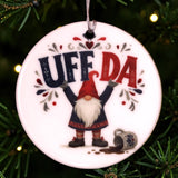 Round white ceramic ornament featuring a Scandinavian tomte gnome, a spilled mug, and the text UFF DA.