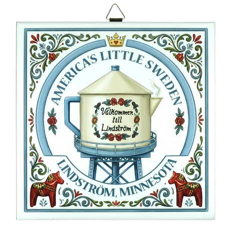 Decorative sign with Lindstrom teapot water tower, Swedish folk art patterns, floral motifs, Dala horses, and text: Americas Little Sweden, Välkommen till Lindström.