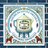 Decorative sign featuring a teapot water tower, floral border, two Dala horses, and text: Americas Little Sweden. Välkommen till Lindström.