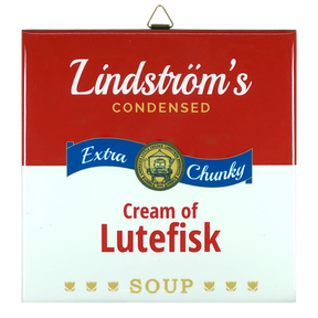 Ceramic wall tile styled like a red and white soup can label; text reads Lindströms Condensed Extra Chunky Cream of Lutefisk Soup, with a gold medal and three fish.