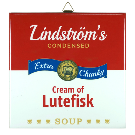 Ceramic wall tile styled like a red and white soup can label; text reads Lindströms Condensed Extra Chunky Cream of Lutefisk Soup, with a gold medal and three fish.
