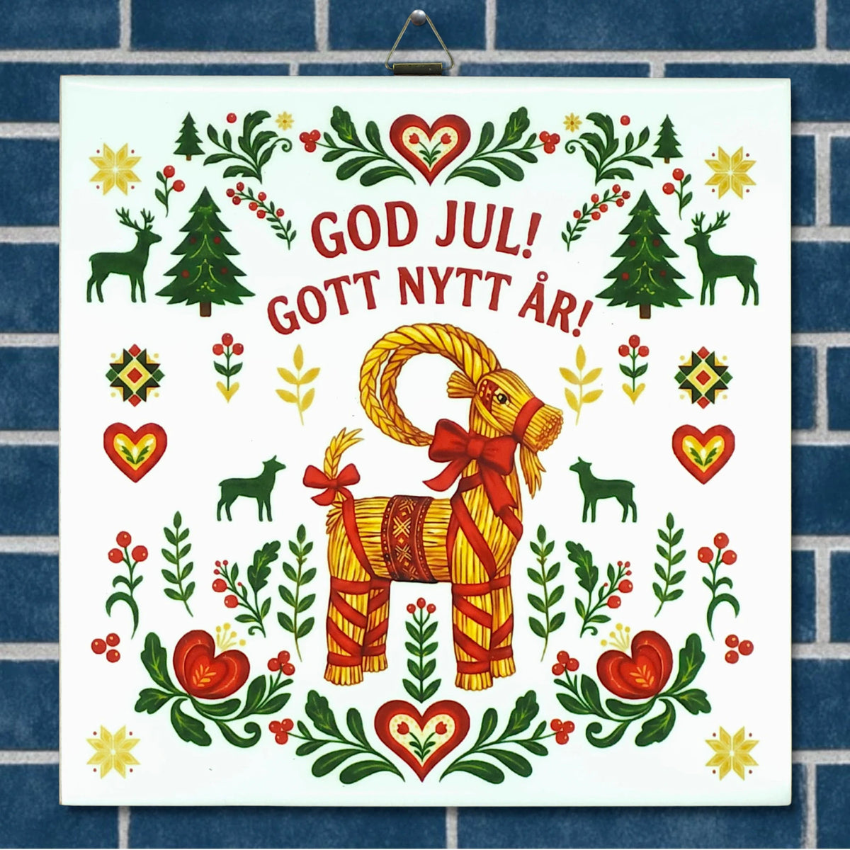 Sign with a straw Swedish Julbock, red hearts, green trees, and floral designs. Text in Swedish reads “God Jul! Gott Nytt År!” on a light background.