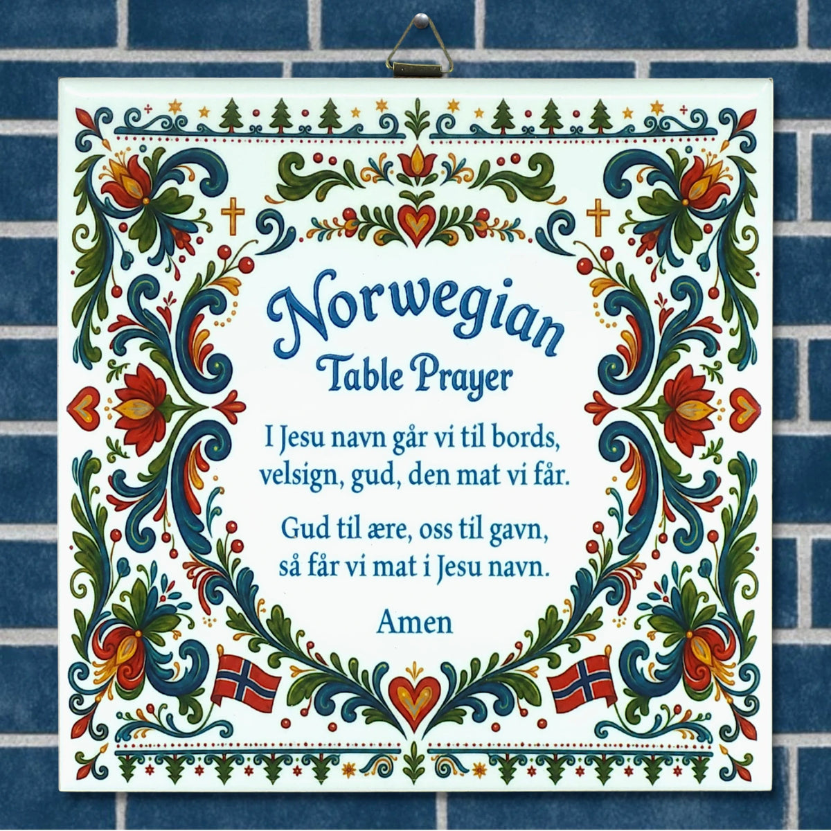 Ceramic wall plaque with blue and white background, floral patterns, Norwegian flags, and the Norwegian Table Prayer shown in both Norwegian and English text.