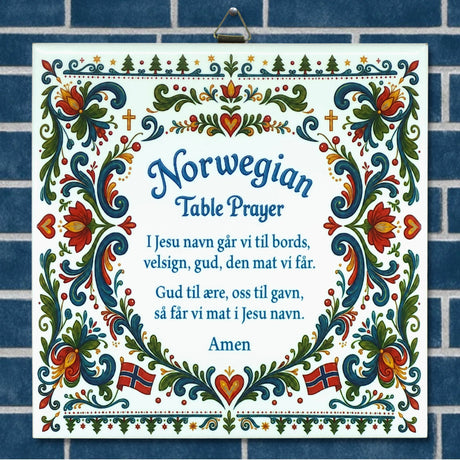 Ceramic wall plaque with blue and white background, floral patterns, Norwegian flags, and the Norwegian Table Prayer shown in both Norwegian and English text.