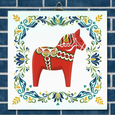 Ceramic tile featuring a red Swedish Dala horse with decorative patterns, centered within a blue brick border and surrounded by colorful floral motifs.