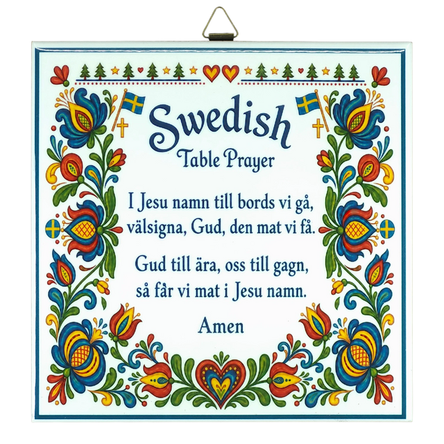 Kurbits trivet featuring floral patterns, Swedish flags, and the Swedish Table Prayer printed in both Swedish and English, ending with the word “Amen.”.