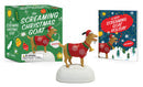 A toy portraying a goat in a festive costume is perched on a white base. The packaging and a card adorned with the text "Book: Screaming Christmas Goat" are visible in the background, making it an ideal holiday gag gift for the season.