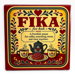 Metal sign with “FIKA” and Swedish coffee break definition, featuring hearts, flowers, coffee cups, teapot, and pastry in red, yellow, and black Scandinavian-style design.