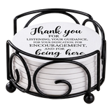 Round white drink coasters stacked in a black metal holder; the top coaster reads, “Thank you for listening, your guidance, and encouragement.”.