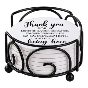 Round white drink coasters stacked in a black metal holder; the top coaster reads, “Thank you for listening, your guidance, and encouragement.”.