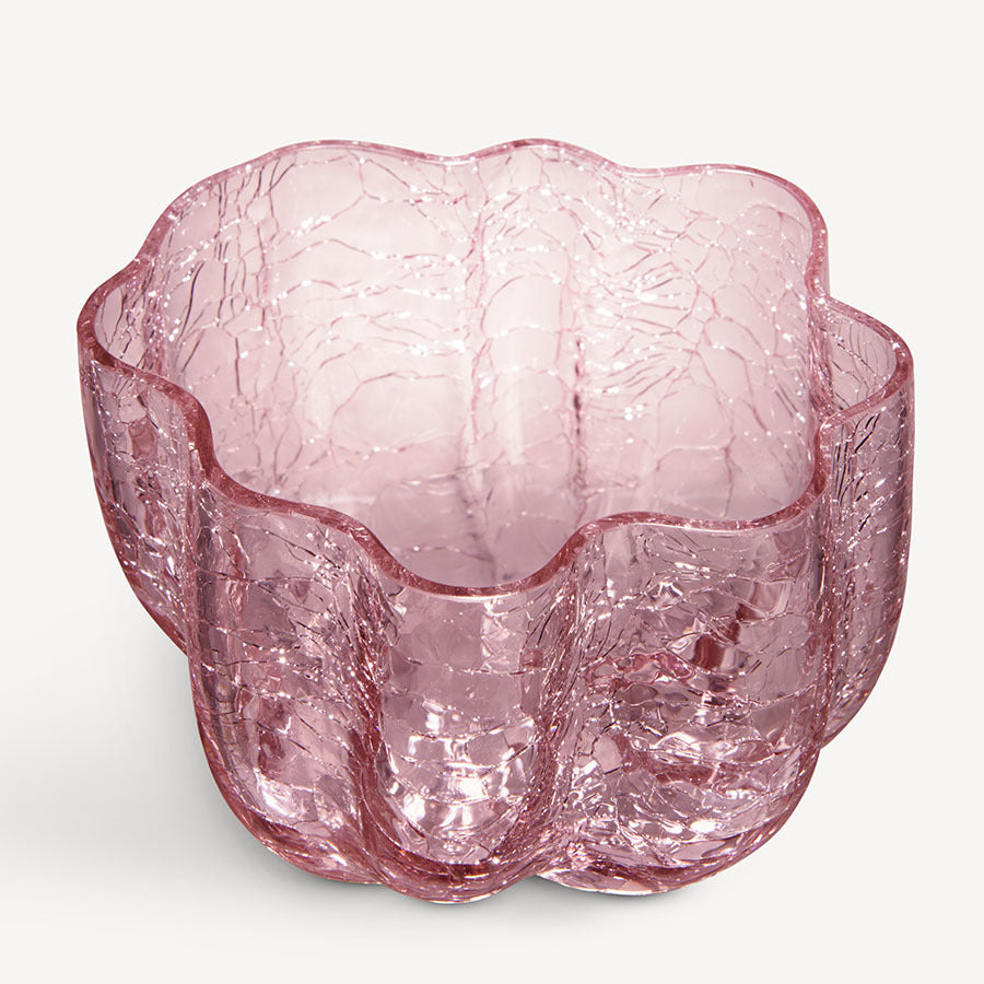 The KostaBoda Crackle Bowl Votive Pink showcases a pink glass design with a rippled rim and a stunningly textured, crackled surface.