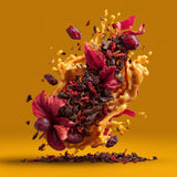 Hibiscus infusion and dried berries floating in a splash of golden liquid.