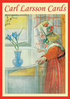 Illustration of a woman in traditional clothing admiring a vase with blue flowers on a table by a window. The text reads "Card Pack: Carl Larsson Greeting Cards 4 Designs 8 Cards & Envelopes", capturing the essence of his vibrant paintings featuring children.