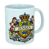 Celebrate your Danish heritage with the Mug: Denmark Coat of Arms Custom Name Ceramic Mug (11 oz Capacity) by Nordic Wholesale. This white ceramic mug showcases a vibrant heraldic crest featuring a crown, lions, and flags, with your custom name displayed in the center and "Danmark" on a banner below—making it a striking personalized tribute to your roots.