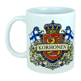 Enjoy your morning coffee in the Nordic Wholesale 11 oz Mug: Finland Coat of Arms Custom Name Ceramic Mug, featuring a vibrant crest with your chosen family name, two Finnish flags, a crowned lion shield, and "Suomi" displayed on a banner at the bottom. This personalized mug is an ideal Finland heritage gift for anyone proud of their roots.