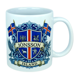 Introducing the Mug: Iceland Coat of Arms Custom Name Ceramic Mug (11 oz Capacity) by Nordic Wholesale—a white ceramic mug featuring a vibrant blue and red Icelandic crest, the custom name “Jónsson” boldly across the center, “Ísland” below, two Icelandic flags, and detailed Landvættir-inspired heraldic symbols including a griffin and a dragon—perfect as a personalized gift to celebrate your Icelandic heritage.
