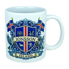 Introducing the Mug: Iceland Coat of Arms Custom Name Ceramic Mug (11 oz Capacity) by Nordic Wholesale—a white ceramic mug featuring a vibrant blue and red Icelandic crest, the custom name “Jónsson” boldly across the center, “Ísland” below, two Icelandic flags, and detailed Landvættir-inspired heraldic symbols including a griffin and a dragon—perfect as a personalized gift to celebrate your Icelandic heritage.