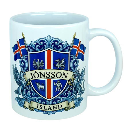 Introducing the Mug: Iceland Coat of Arms Custom Name Ceramic Mug (11 oz Capacity) by Nordic Wholesale—a white ceramic mug featuring a vibrant blue and red Icelandic crest, the custom name “Jónsson” boldly across the center, “Ísland” below, two Icelandic flags, and detailed Landvættir-inspired heraldic symbols including a griffin and a dragon—perfect as a personalized gift to celebrate your Icelandic heritage.