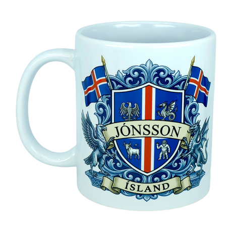 This Mug: Iceland Coat of Arms Custom Name Ceramic Mug (11 oz) by Nordic Wholesale features a white design adorned with a blue and red Icelandic crest, the surname Jónsson on a banner, national flags, mythical landvættir creatures, and "ÍSLAND" at the base—an eye-catching tribute to Icelandic heritage.