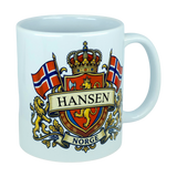 Introducing the Mug: Norway Coat of Arms Custom Name Ceramic Mug (11 oz Capacity) by Nordic Wholesale—a white ceramic mug showcasing a vibrant Norwegian coat of arms design. It features two Norwegian flags, a crown, lions, and a customizable banner for your family name above the word "NORGE." This personalized mug is an ideal Norway heritage gift for anyone proud of their roots.
