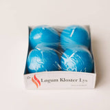 A pack of four 2.5″ round blue Danish ball candles by Talla Imports, from their Logum Kloster Lys line, wrapped in plastic. The front label displays “Løgum Kloster Lys” with a small flame logo and “Made in Denmark” printed underneath—perfect for infusing your home with the warm, cozy ambiance of Scandinavian décor and hygge.