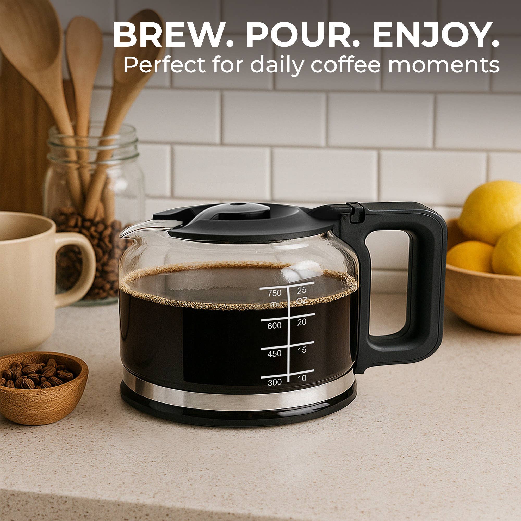 A Kaffe Universal Replacement Coffee Carafe – 5-Cup Durable Glass Pot filled with fresh coffee sits on a kitchen counter beside a mug, utensils, coffee beans, and lemons. Text above: Brew. Pour. Enjoy. Perfect for most 5-cup coffee makers.