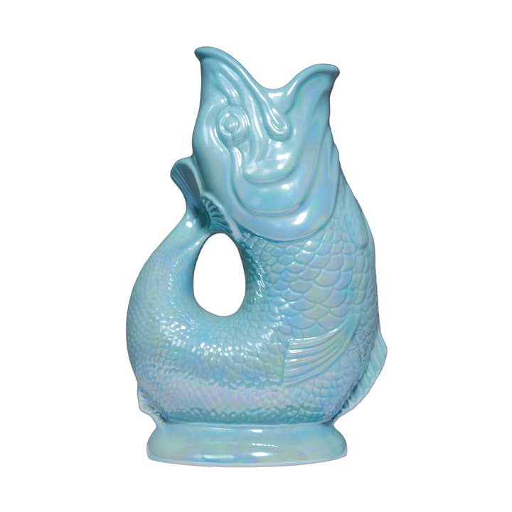 The Gluggle Jug Lustre by Faire - The Original Gluggle Jug Factory is a glossy, light blue, fish-shaped pitcher with a scale pattern, open mouth spout, and curved tail handle—an eye-catching addition to any table. Made in Europe.