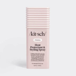 A pink spray bottle with a black pump, labeled “Kitsch,” standing upright on a plain white background.