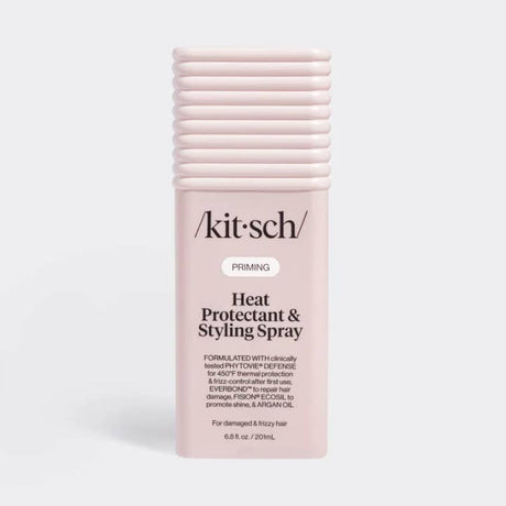 A pink spray bottle with a black pump, labeled “Kitsch,” standing upright on a plain white background.