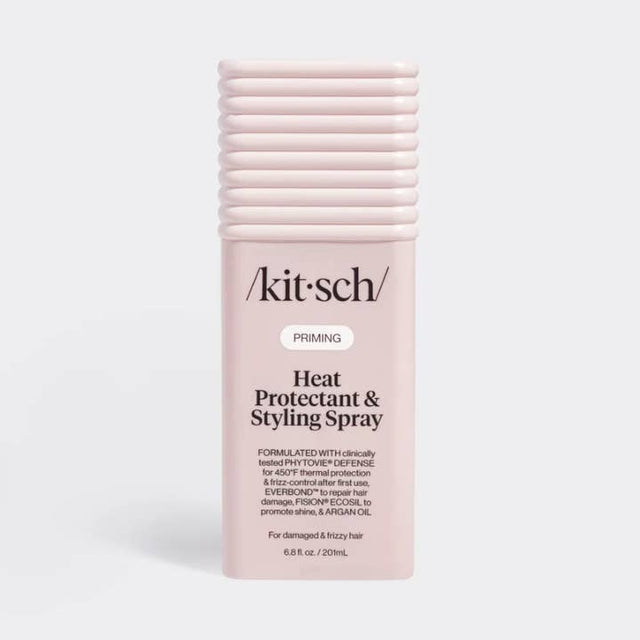 A pink spray bottle with a black pump, labeled “Kitsch,” standing upright on a plain white background.