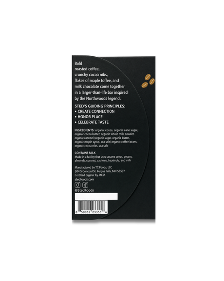 Back of a black food package with ingredient list, guiding principles, maker details, three coffee beans, barcode, and partial bean-to-bar chocolate graphic visible.