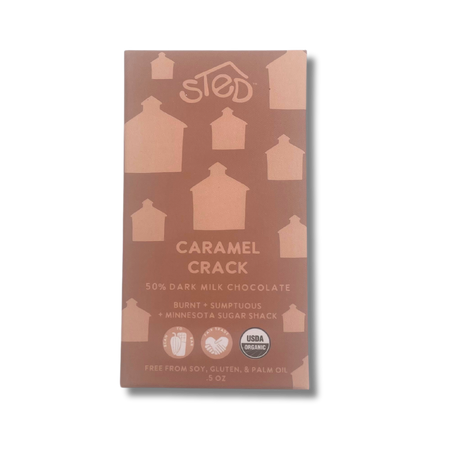 Chocolate bar with house silhouettes on the packaging, USDA Organic logo, and text noting “burnt” flavor and free from soy, gluten, and palm oil.