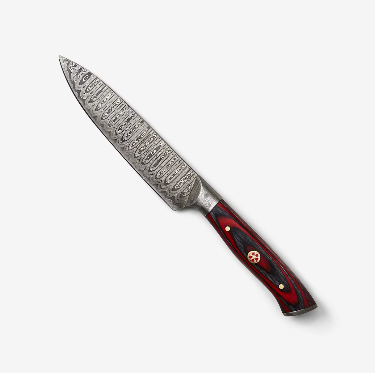 Patterned Damascus steel blade chef’s knife with a red and black handle, brass rivets, and a circular emblem, displayed on a white background.