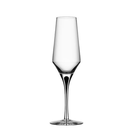A clear, empty Orrefors Metropol Champagne Glass 9oz with a long stem and slightly tapered bowl, set against a plain white background.