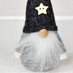 Scandinavian gnome figurine with a grey wool felt hat, a white star ornament, and a long white beard.