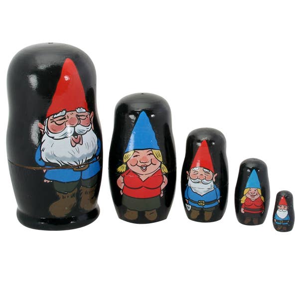 The Figurine: Gnomes Nesting Dolls Family of 5 Gnomes features five black nesting dolls with painted gnome faces and red or blue hats, arranged from largest to smallest.