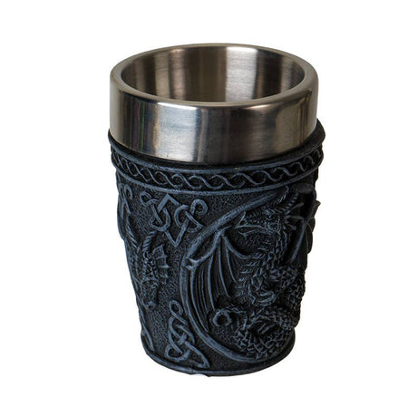 The Shot Glass: Medieval Dragon Shot Glass features a black exterior with embossed dragon and Celtic knot designs, plus a stainless steel insert for easy cleaning and durability.