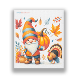 Swedish dishcloths featuring a gnome holding a pumpkin, standing beside a turkey among autumn leaves and pumpkins.