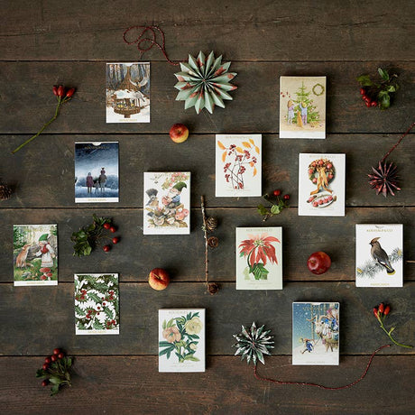 Ten charming Christmas cards featuring kids and a tree, with two festive designs by Koustrupco, come with envelopes—ideal for use as Scandinavian Christmas cards or mini gift cards.